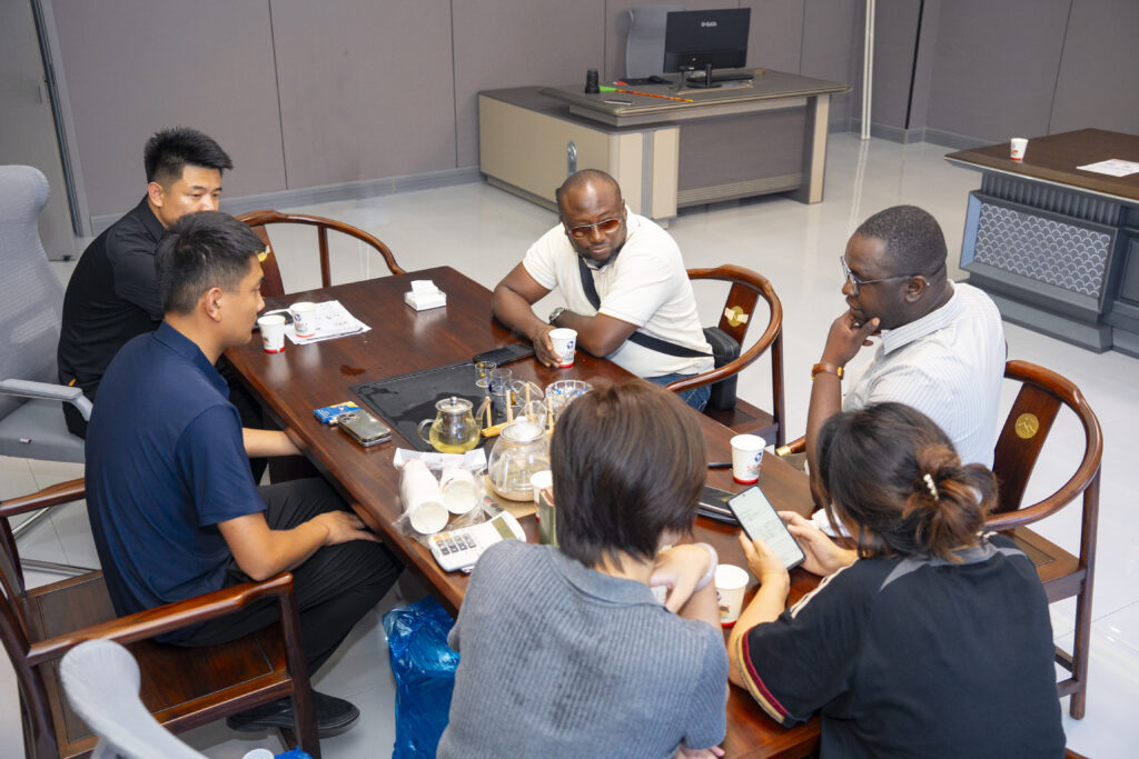 LN Group business meeting with African buyers at the 22nd China Liangshan Special Purpose Vehicle Exhibition, discussing heavy trucks and semi trailer cooperation